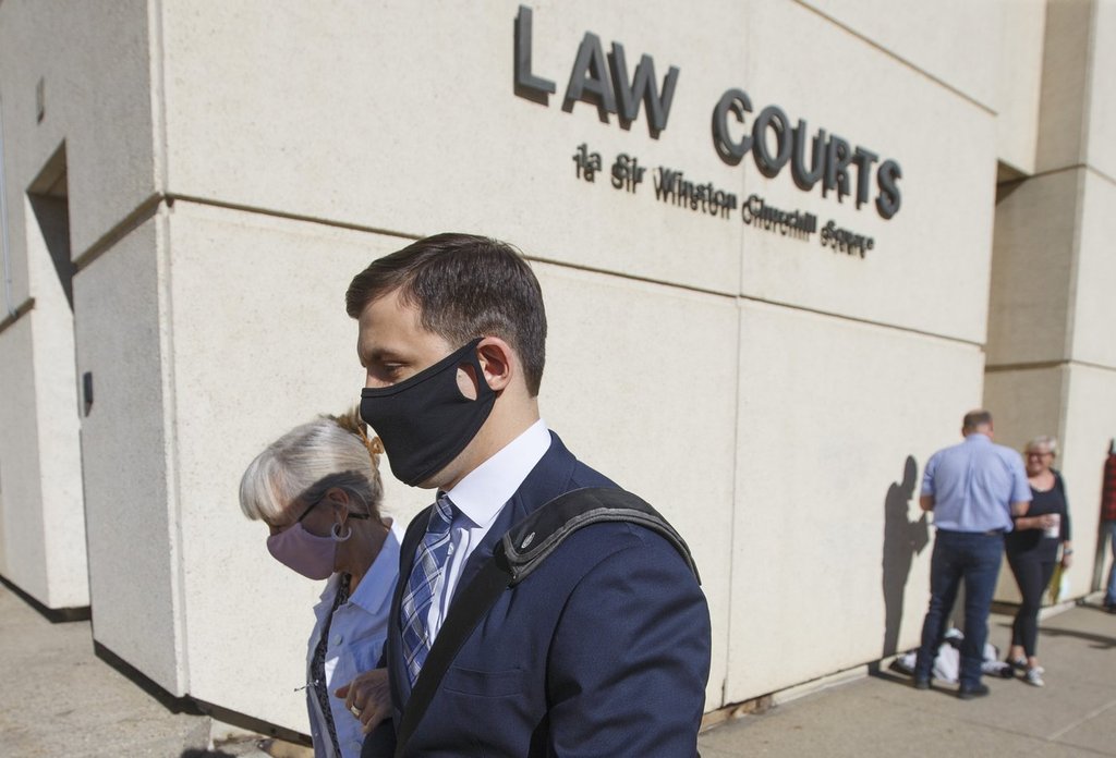 Matthew McKnight and his mother walk into court in Edmonton on Friday, July 10, 2020. THE CANADIAN PRESS/Jason Franson.