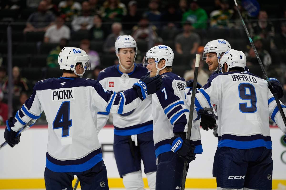 Winnipeg Jets center Vladislav Namestnikov (7) celebrates with teammates after scoring a goal during the second period of an NHL hockey preseason game against the Minnesota Wild, Tuesday, Sept. 30, 2025, in St. Paul, Minn. (AP Photo/Abbie Parr).